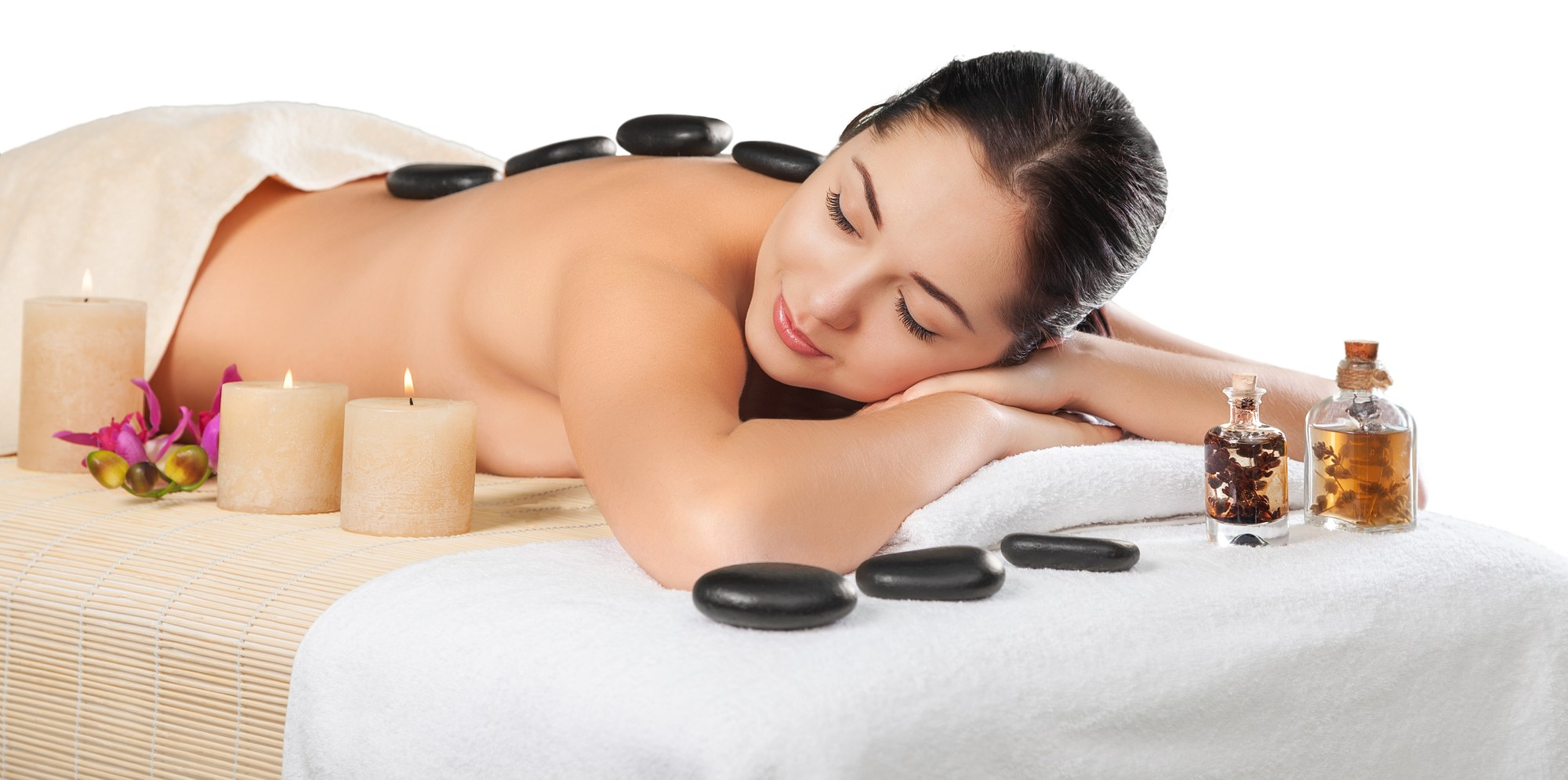 beautiful young woman receiving hot stone massage