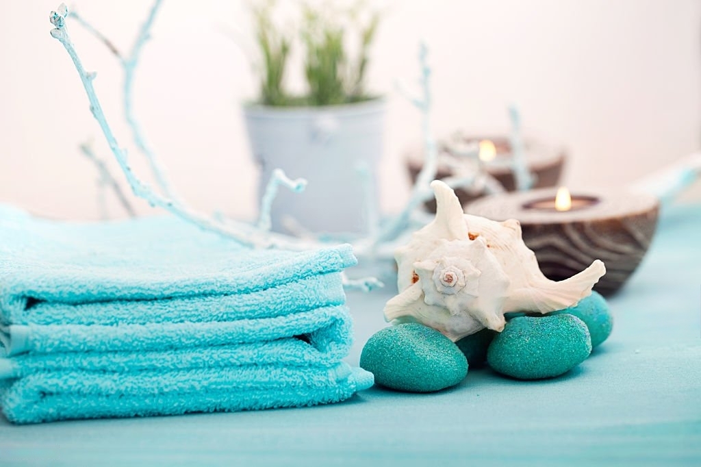 aqua colored spa towels, shells and candles