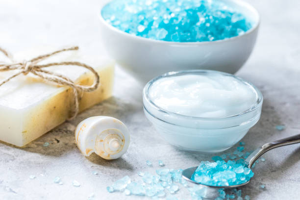 blue sea salt, soap and body cream in treatment set on stone desk background